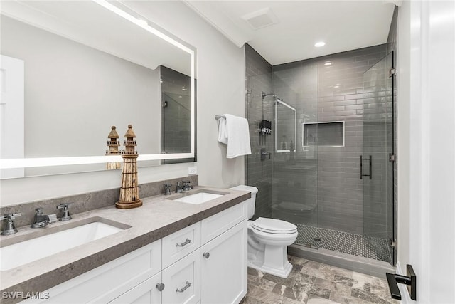 bathroom featuring a shower with door, vanity, and toilet