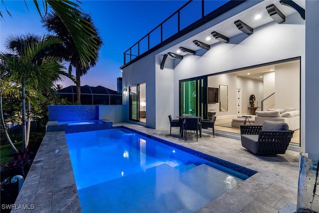 view of pool featuring a patio area, an outdoor hangout area, and an in ground hot tub