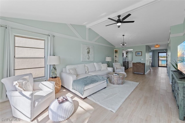 living room featuring vaulted ceiling with beams, ceiling fan with notable chandelier, a wealth of natural light, and light hardwood / wood-style floors