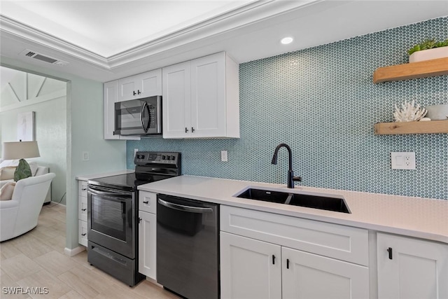 kitchen with black range with electric cooktop, white cabinets, sink, and dishwasher