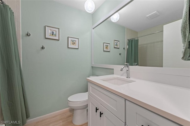 bathroom featuring hardwood / wood-style flooring, vanity, and toilet