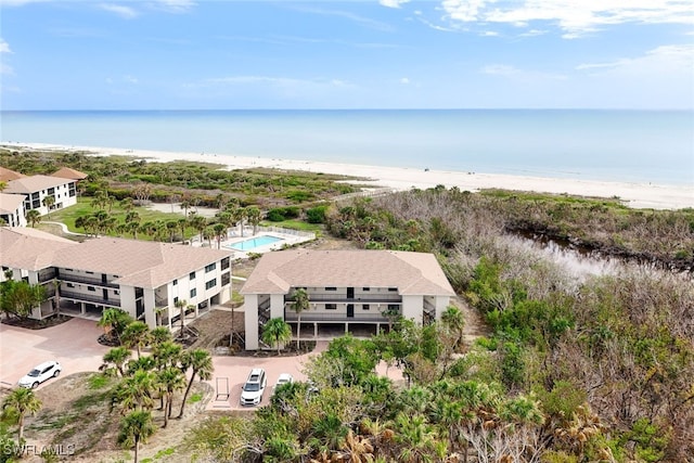 birds eye view of property featuring a view of the beach and a water view