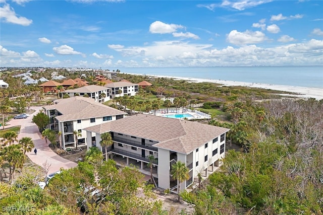 aerial view with a water view and a view of the beach