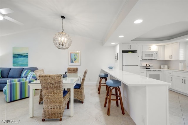 tiled dining area with crown molding, ceiling fan with notable chandelier, and lofted ceiling