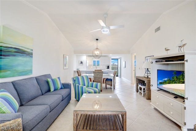 living room with light tile patterned floors, ceiling fan with notable chandelier, and lofted ceiling