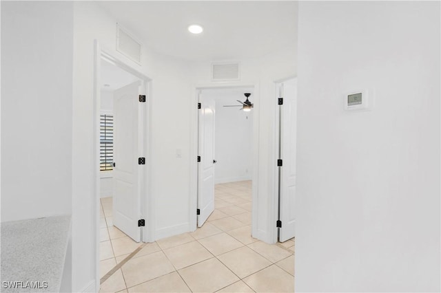 hall featuring light tile patterned floors