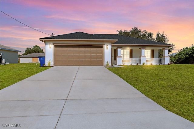 view of front of house with a garage and a yard