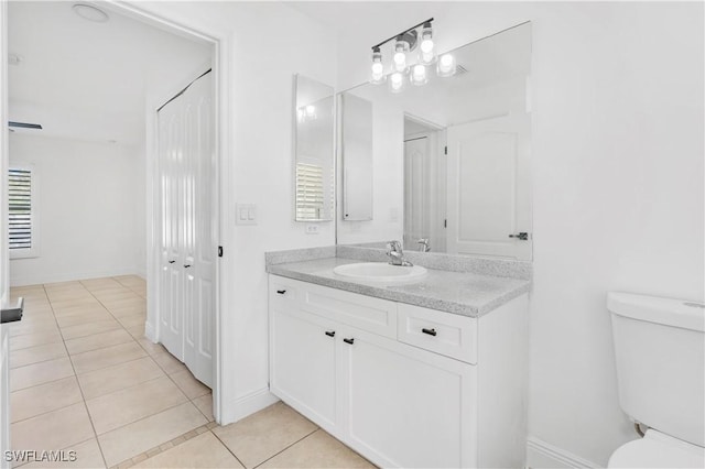 bathroom featuring vanity, tile patterned floors, and toilet