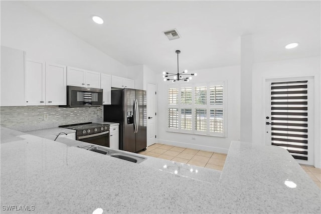 kitchen with pendant lighting, light tile patterned floors, light stone counters, white cabinets, and stainless steel fridge with ice dispenser