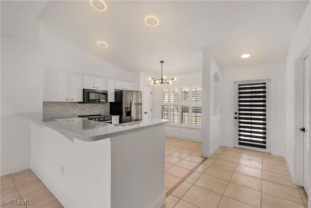 kitchen featuring decorative light fixtures, stainless steel fridge, kitchen peninsula, decorative backsplash, and white cabinets