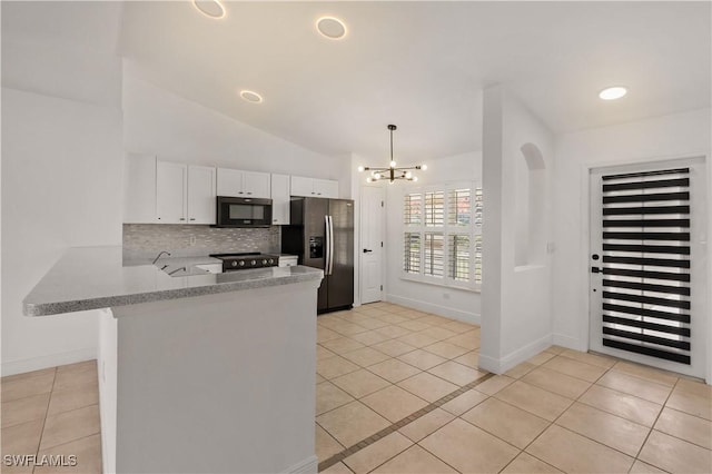 kitchen featuring stainless steel fridge, white cabinetry, tasteful backsplash, decorative light fixtures, and kitchen peninsula