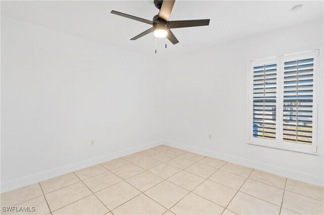 unfurnished room with light tile patterned floors and ceiling fan