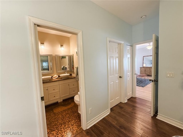 hallway featuring sink and dark hardwood / wood-style flooring