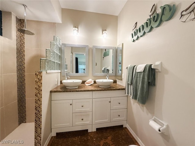 bathroom featuring vanity and tiled shower