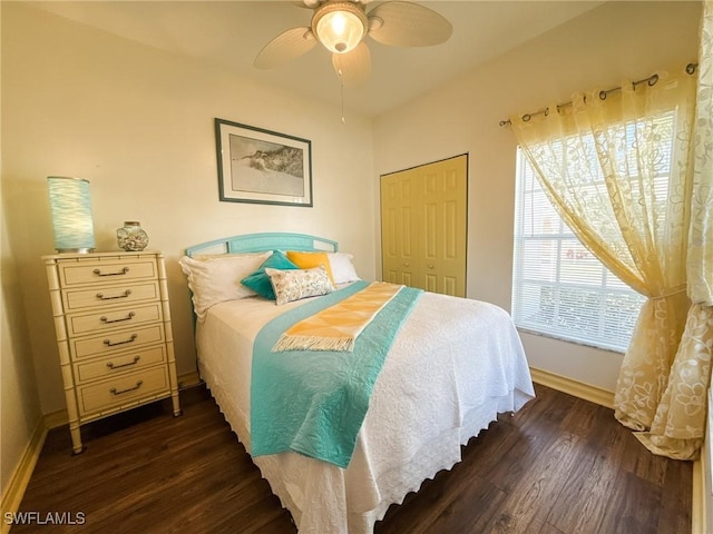 bedroom with ceiling fan, dark hardwood / wood-style flooring, and a closet