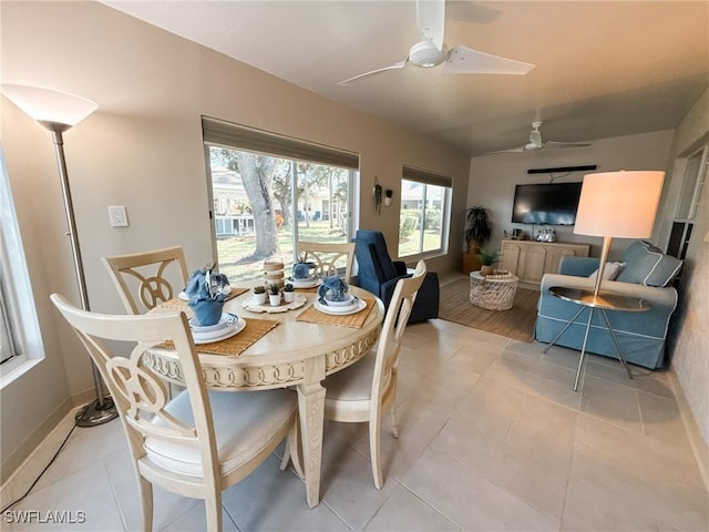 tiled dining space with ceiling fan