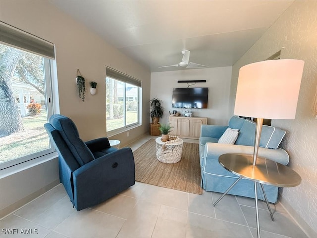 tiled living room with ceiling fan