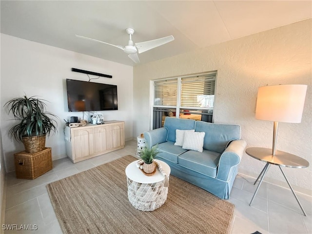 tiled living room with ceiling fan