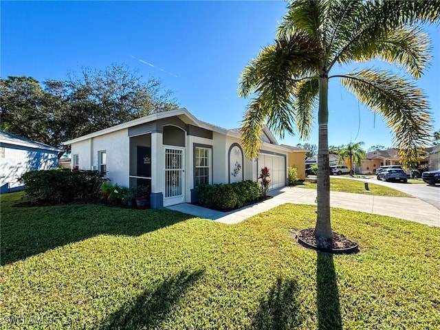 ranch-style home featuring a garage and a front lawn