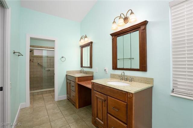 bathroom with tile patterned floors, vanity, and a shower with shower door