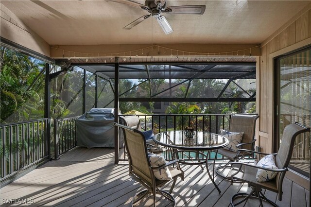 sunroom / solarium featuring ceiling fan