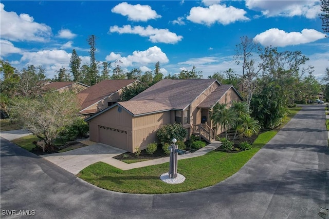 view of front of house with a garage and a front lawn