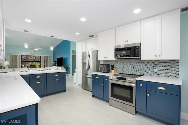 kitchen with blue cabinetry, white cabinets, stainless steel appliances, and decorative light fixtures