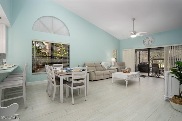 living room featuring ceiling fan and high vaulted ceiling