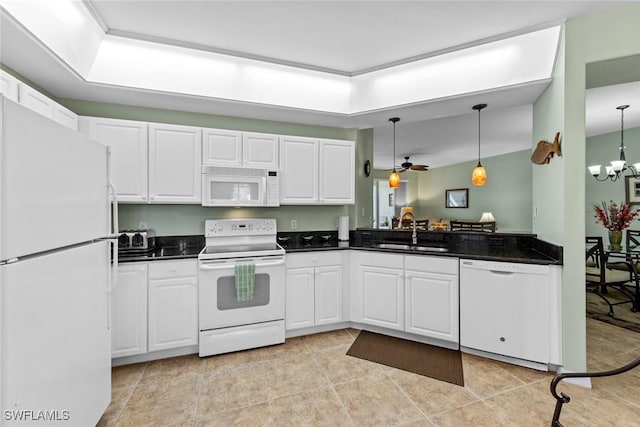 kitchen featuring sink, hanging light fixtures, white appliances, white cabinets, and ceiling fan with notable chandelier