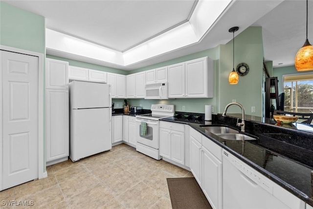 kitchen featuring white appliances, sink, pendant lighting, dark stone countertops, and white cabinets