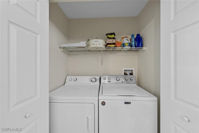 clothes washing area with washing machine and dryer