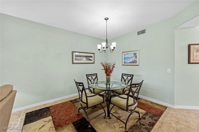 tiled dining area featuring a notable chandelier