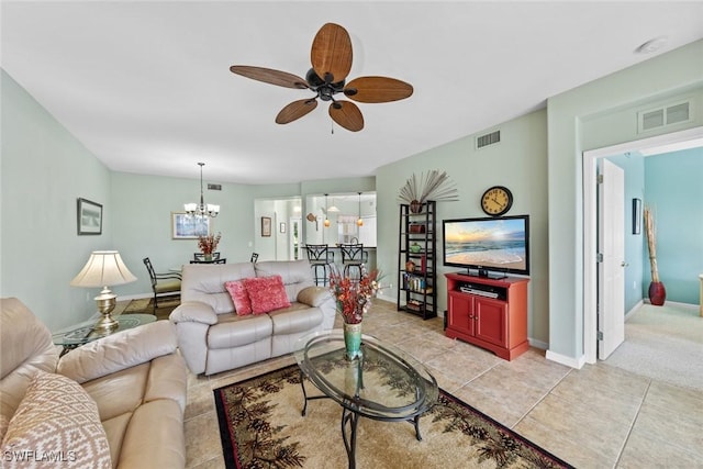 living room with light tile patterned floors and ceiling fan with notable chandelier