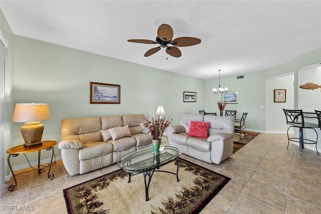 living room featuring ceiling fan with notable chandelier