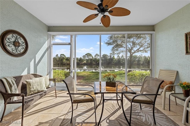 sunroom / solarium featuring ceiling fan and a healthy amount of sunlight