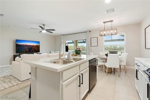 kitchen featuring white cabinetry, sink, dishwasher, decorative light fixtures, and a kitchen island with sink