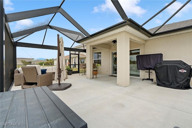 view of patio / terrace featuring glass enclosure and ceiling fan