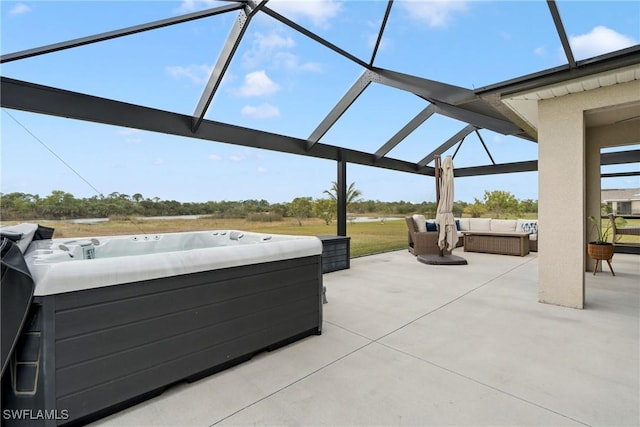 view of patio with a lanai and a hot tub