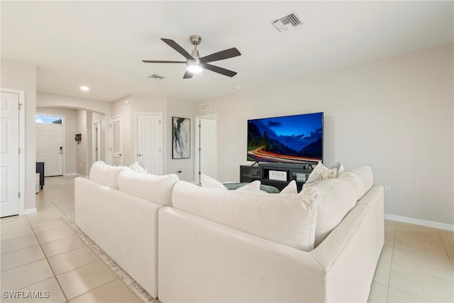 tiled living room featuring ceiling fan