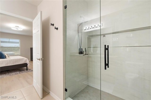 bathroom with tile patterned floors and a shower with shower door