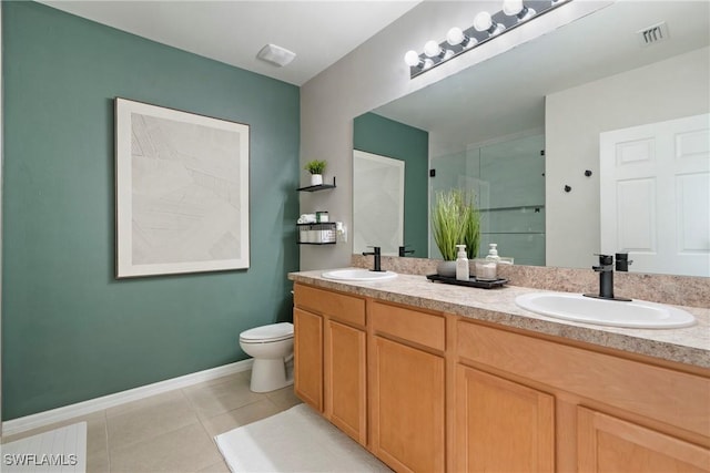 bathroom with tile patterned flooring, vanity, toilet, and walk in shower