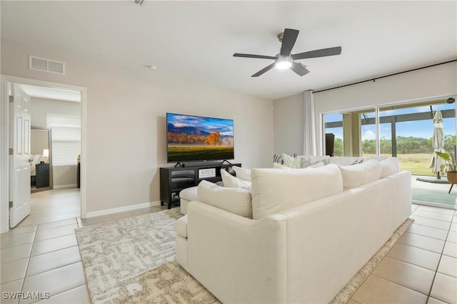 tiled living room featuring ceiling fan