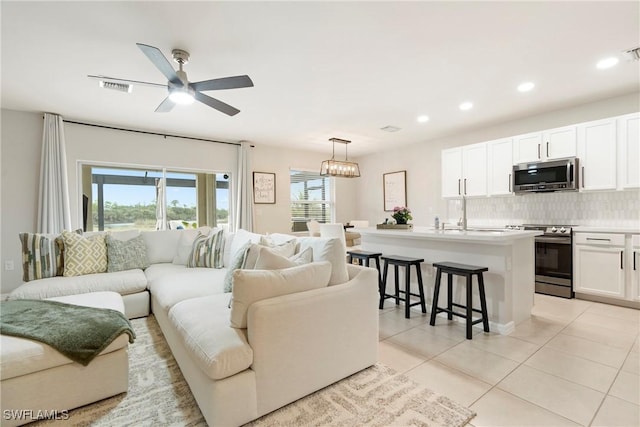 tiled living room featuring ceiling fan