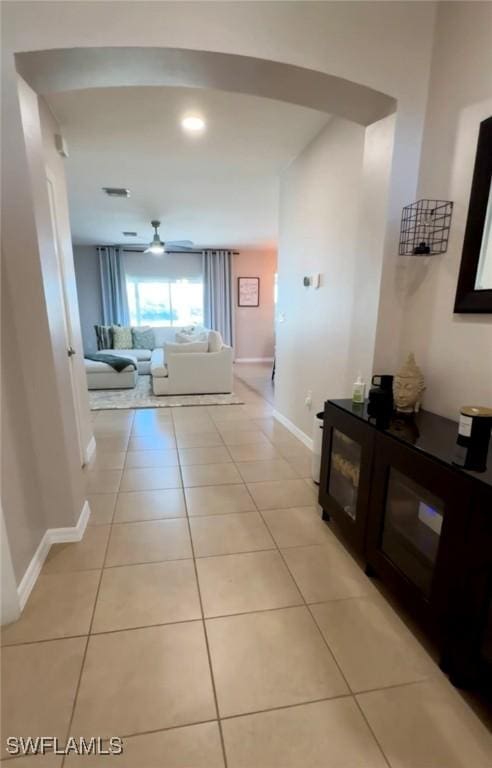 corridor featuring light tile patterned floors