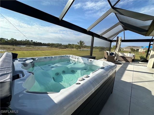 view of pool featuring a lawn, a patio, and a hot tub