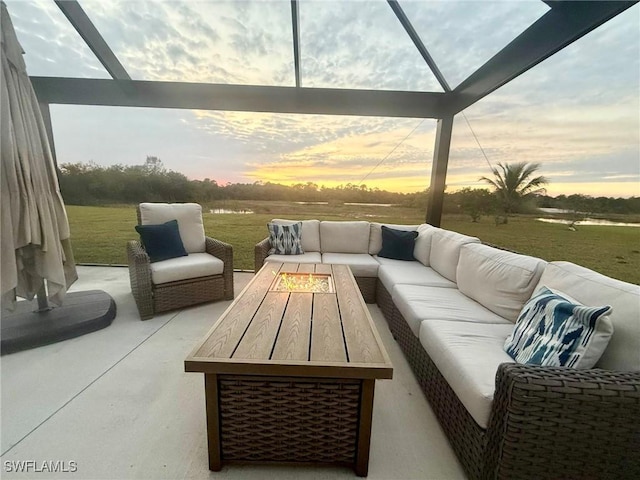 patio terrace at dusk featuring an outdoor living space with a fire pit