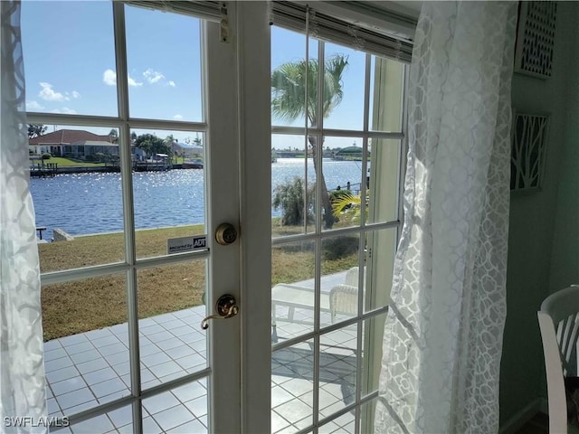 doorway featuring french doors, a water view, and a wealth of natural light