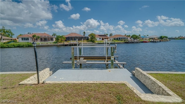 dock area featuring a water view and a lawn