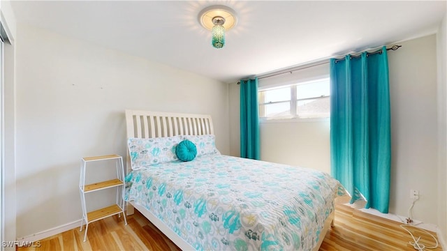 bedroom with wood-type flooring