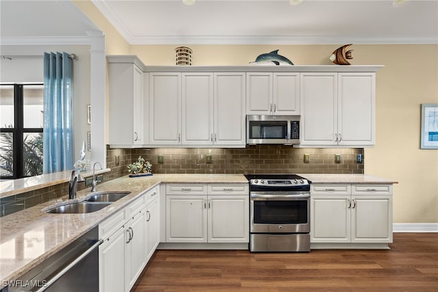 kitchen featuring white cabinetry, appliances with stainless steel finishes, dark hardwood / wood-style floors, ornamental molding, and sink